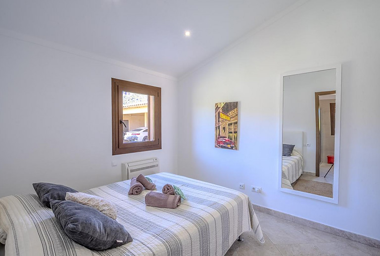 Schlafzimmer mit Doppelbett und Spiegel