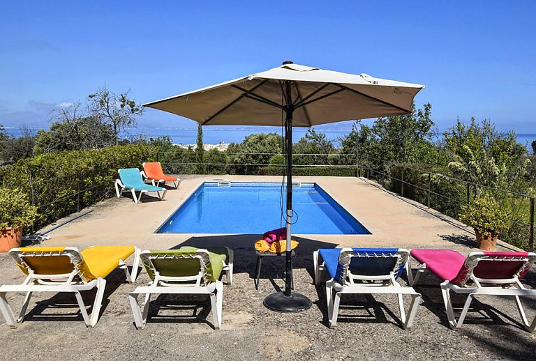 Sonnenliegen am Pool mit Meerblick