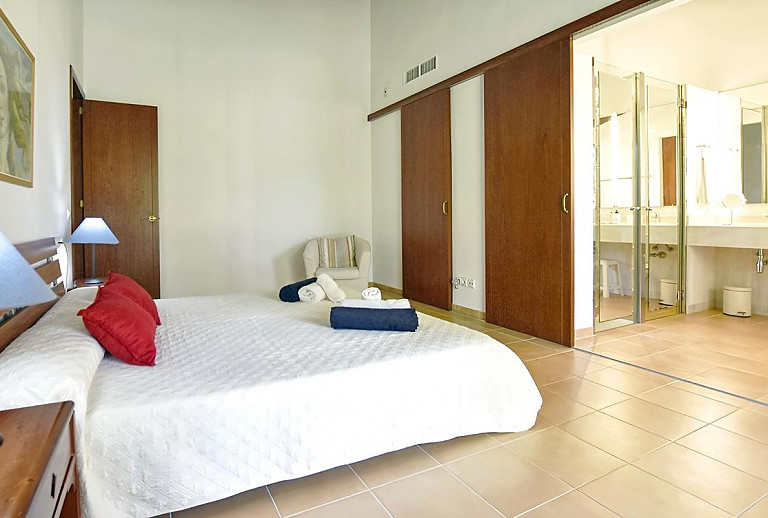 Schlafzimmer mit Doppelbett und Badezimmer