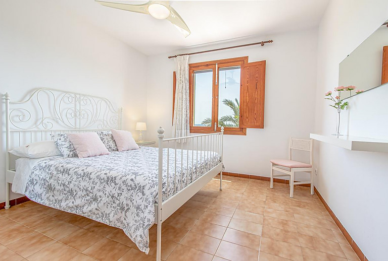 Schlafzimmer mit Doppelbett und Spiegel