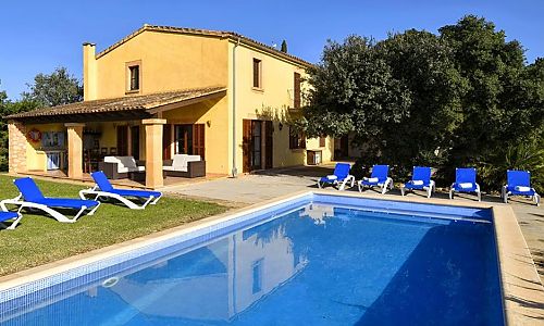 Poolbereich mit Sonnenliegen vor der Finca