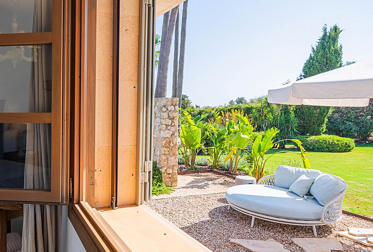 Garten mit Tagesbett unter dem Sonnenschirm