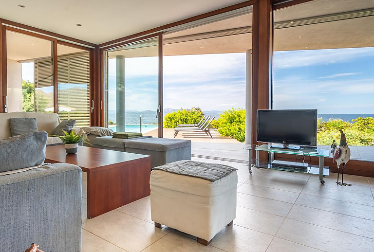 Wohnzimmer mit Blick auf den Pool und das Meer