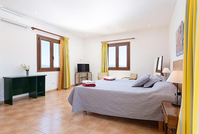 Schlafzimmer mit Doppelbett und Schreibtisch