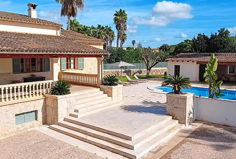 Poolterrasse mit Sonnenliegen vor der Finca